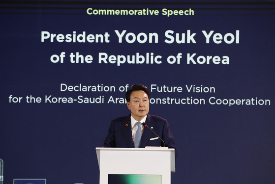 President Yoon Suk Yeol speaks at a ceremony marking 50 years of construction cooperation between Korea and Saudi Arabia at a NEOM exhibition center in Riyadh on Monday. [JOINT PRESS CORPS]
