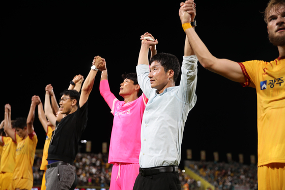 Gwangju FC manager Lee Jung-hyo, second from right, celebrates with his team. [K LEAGUE] 