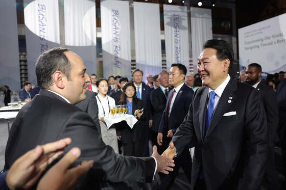 President Yoon Suk Yeol, right, greets Dimitri Kerkentzes, secretary general of the Bureau International des Expositions (BIE), at the official reception for Busan’s 2030 World Expo bid at the BIE general assembly in Paris on June 21. [JOINT PRESS CORPS]