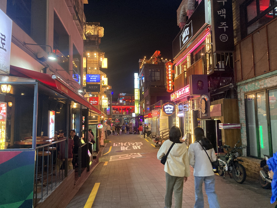 People walk the streets of Itaewon and dine in restaurants in the area on Wednesday. [CHO JUNG-WOO] 