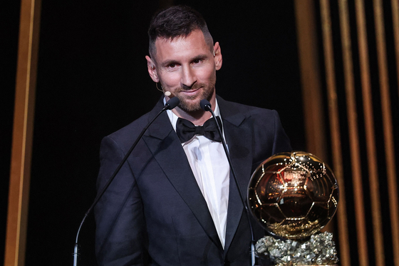 Inter Miami's Argentine forward Lionel Messi reacts on stage next to his trophy as he receives his 8th Ballon d'Or award during the 2023 Ballon d'Or France Football award ceremony at the Theatre du Chatelet in Paris on Monday.  [AFP/YONHAP]