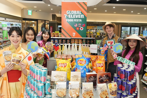 Models from 7-Eleven showcase products sourced directly from five overseas 7-Eleven stores, which are now available for purchase at 7-Eleven branches in Korea. [7-ELEVEN]