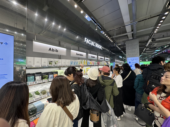 The display wall of the Olive Young Myeong-dong Town branch, known for its foreigner tailored store concept, showcases a vast array of face masks. They stand out as a particularly popular choice for foreign customers, according to the company. [SEO JI-EUN]