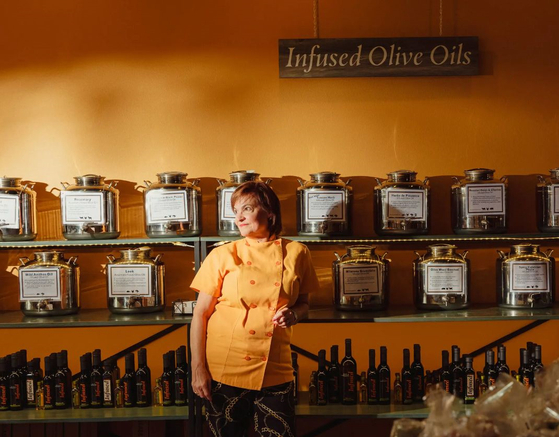 Michelle Spangler at Infused Oils & Vinegars in Dallas on Tuesday, Oct. 10, 2023. Spangler, owner of Infused Oils & Vinegars in Dallas, expects to pay up to 20 percent more for olive oil from her supplier. [Zerb Mellish/The New York Times]