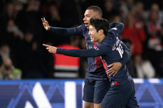 Paris Saint-Germain's Kylian Mbappe, left, and Lee Kang-in celebrate a goal during the French Ligue 1 football match between Paris-Saint Germain and Montpellier at Parc des Princes in Paris on Friday. [XINHUA]