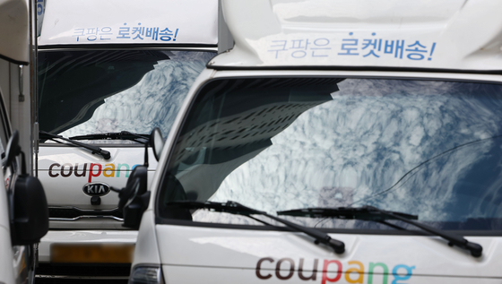 Coupang, the U.S.-listed Korean e-commerce giant, reported revenue reaching $6.18 billion, up 21 percent compared to the same period last year, marking the largest quarterly revenue. The company's delivery vehicles are pictured at a parking lot in Seoul on Aug. 9. [YONHAP]