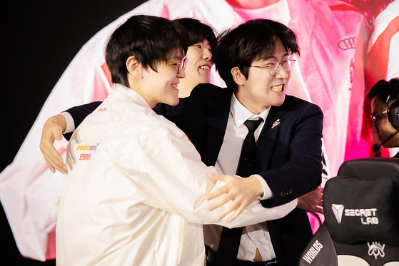 Wei ″Weiwei″ Bohan, left, Kang ″TheShy″ Seung-lok and Coach Yang ″Daeny″ Dae-in of Weibo Gaming react after victory at the 2023 League of Legends World Championship on Saturday in Busan. [RIOT GAMES]