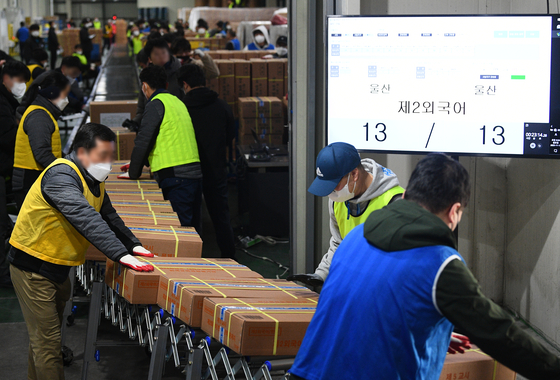 Workers sort boxes of exam papers and answer sheets for the Suneung, Korean College Scholastic Ability Test at a printing plant in Sejong on Monday morning, three days ahead of the exam. The boxes are shipped to storage facilities in 84 regional exam units nationwide. Exam papers will be distributed to 1,279 test sites on Thursday morning. [YONHAP]