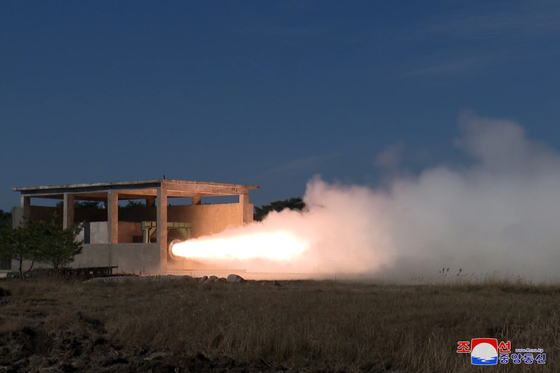 In this photo released by Pyongyang's state-controlled Korean Central News Agency on Wednesday, the ground test of a new solid-fuel missile engine for the North's intermediate-range ballistic missiles is underway. [YONHAP]