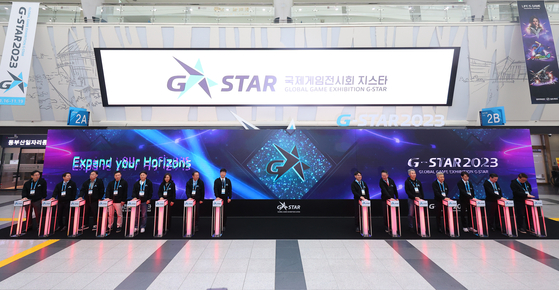 Officials from the Ministry of Culture, Sports and Tourism, the Korea Association of Game Industry (K-Games), Busan city government and participating companies pose for a photo during the opening ceremony of G-Star 2023 held at Bexco, Busan, on Thursday morning. [YONHAP] 