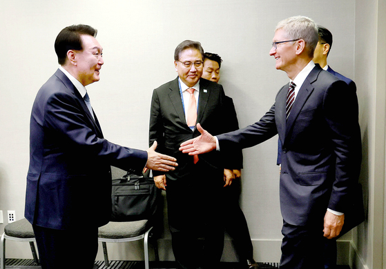 President Yoon Suk Yeol, left, greets Apple CEO Tim Cook at their surprise meeting on the margins of the APEC summit in San Francisco on Wednesday. [PRESIDENTIAL OFFICE]