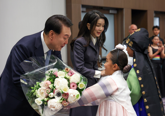 President Yoon Suk Yeol, left, and first lady Kim Keon Hee receive flowers from children at a luncheon with Korean residents in San Francisco on Wednesday. [JOINT PRESS CORPS]