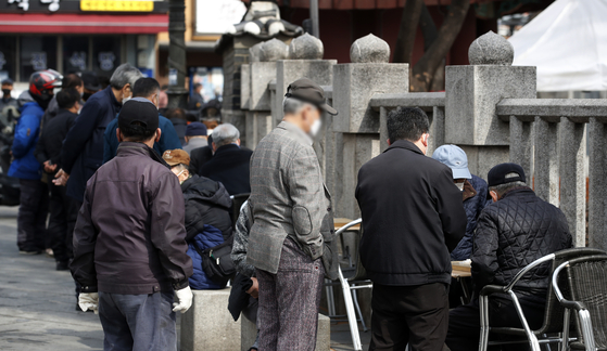 Members of the elderly population play Korean chess outside of Tapgol Park in Seoul on March 3, 2021. [NEWS1] 