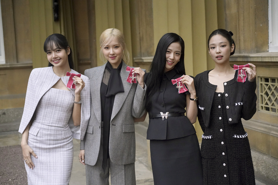 From left, Lisa, Rosé, Jisoo and Jennie, from Blackpink, pose with their MBE, Members of the Order of the British Empire, medals awarded to them in recognition of their role as COP26 advocates for the COP26 Summit in Glasgow 2021, by King Charles at Buckingham Palace in London on Wednesday. [YONHAP]