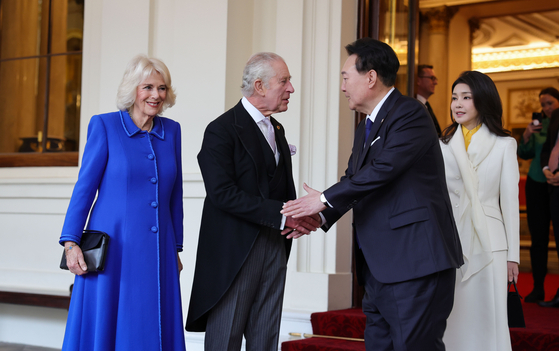 Korea's President Yoon Suk Yeol, center right, accompanied by first lady Kim Keon Hee, bids farewell to Britain's King Charles III, center left, and Queen Camilla at Buckingham Palace in London Thursday on the last day of Yoon’s four-day state visit. He heads next to France. [JOINT PRESS CORPS]