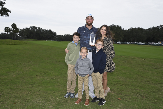 Chris Kirk poses with his family as he receives the Courage Award prior to the RSM Classic at Sea Island Golf Club in St. Simons Island, Georgia on Nov. 14.  [GETTY IMAGES]