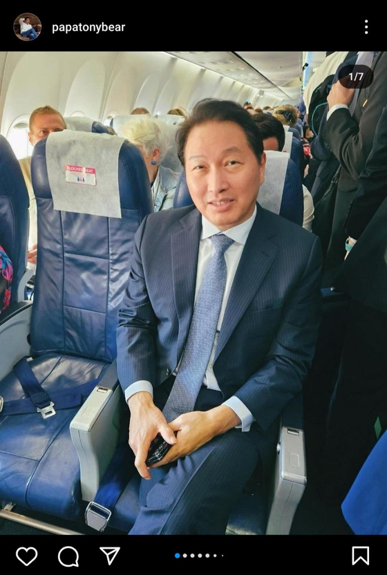 SK Group Chairman Chey Tae-won sits in the economy class section of an airplane while making a trip to a Bureau International des Expositions member state to promote Busan's bid for the World Expo 2030. [SCREEN CAPTURE]
