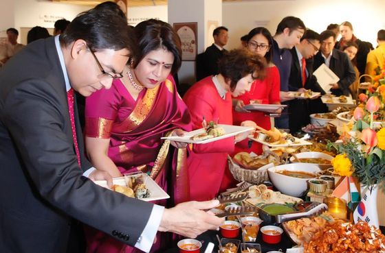 From left, Indian Ambassador Amit Kumar and his wife Surabhi Kumar join members of the Korean Food Promotion Institute and Ministry of Agriculture, Food and Rural Affairs, to celebrate the inauguration of the Korea-India Food Culture Exchange Program at the Hansik Space E:eum at the institute on Nov. 17. The event was organized as part of Sarang, the annual flagship cultural program organized by the Embassy of India. [EMBASSY OF INDIA IN KOREA]
