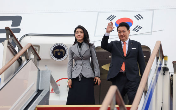 President Yoon Suk Yeol, right, and first lady Kim Keon Hee wave farewell aboard the presidential plane at Seoul Air Base before departing for their state visit to the Netherlands on Monday, marking Korea's first state visit to the European country since the two established diplomatic relations in 1961. [JOINT PRESS CORPS] 