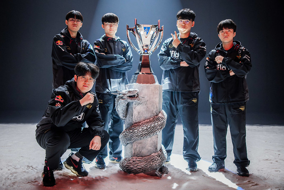Members of Korean League of Legends team T1 pose with the final trophy after winning the 2023 World Championship at Gocheok Sky Dome in western Seoul on Nov. 19. [RIOT GAMES]