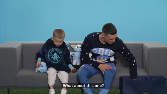 Phil Foden, right, reviews some of the Manchester City gifts with his son Ronnie Foden. [ONE FOOTBALL]  