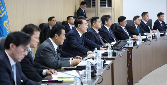 President Yoon Suk Yeol, fourth from left, speaks at a National Security Council meeting at the Yongsan presidential office in central Seoul on Monday after North Korea launched a long-range missile into the East Sea earlier in the morning. [PRESIDENTIAL OFFICE]