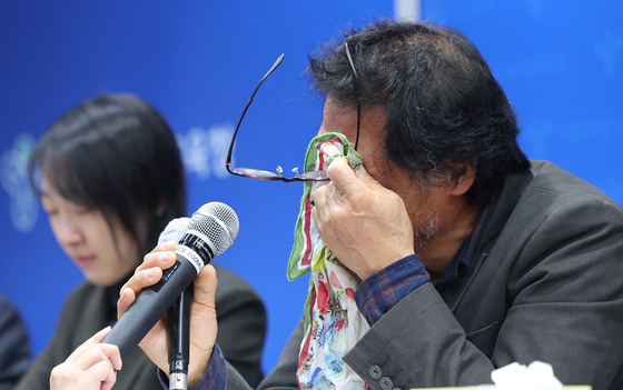 The father of the deceased teacher at Sangmyung University Teacher’s College Experimental Elementary School in central Seoul, who took her own life in January due to parents' bullying, wipes his tears during a press conference held at Seoul Metropolitan Office of Education in downtown Seoul on Friday. [NEWS1] 