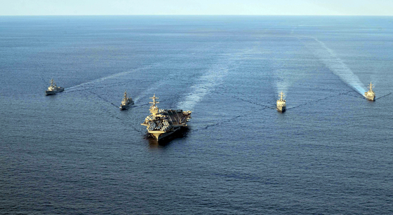 The aircraft carrier USS Carl Vinson, center, leads a group of South Korean, U.S. and Japanese destroyers for a trilateral exercise south of Jeju Island on Nov. 26. On the left of the USS Carl Vinson is the USS Kidd and the JS Kirisame, while on the right is the ROKS Sejong the Great and the USS Sterett. [U.S. NAVY]