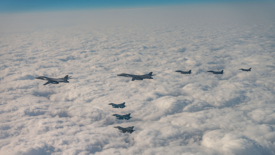Two U.S. B-1B strategic bombers are seen escorted by South Korean F-15K, U.S. F-16 and Japanese F-2 fighter jets in an aerial exercise over waters east of Jeju Island on Wednesday. [JOINT CHIEFS OF STAFF]