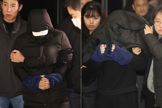 A teenage couple suspected of vandalizing Gyeongbok Palace's walls on Saturday walk into Jongno Police Precinct in Jongno District, central Seoul, Tuesday night. [YONHAP] 