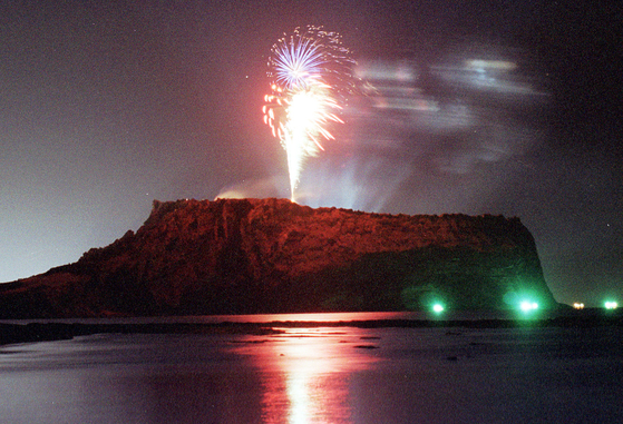Fireworks go off at Seongsan Ilchulbon, also known as "sunrise peak," on Jeju Island [YONHAP]