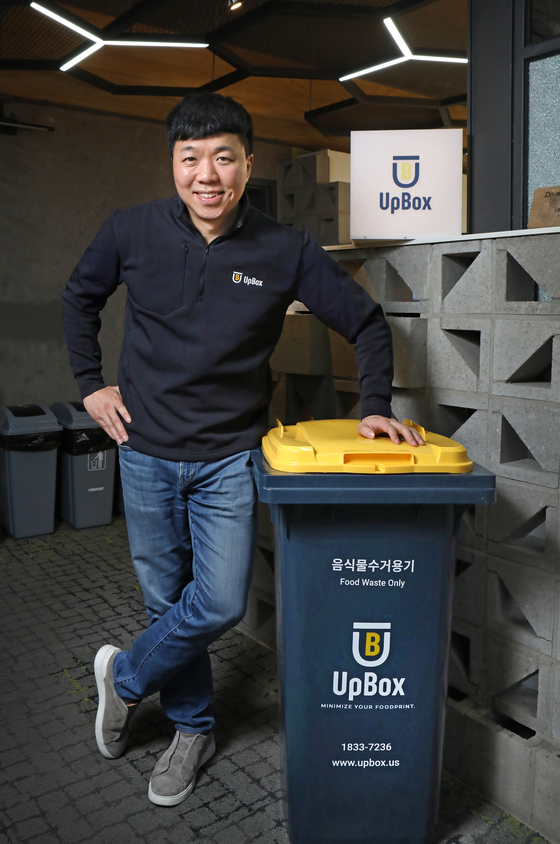 Reco CEO Kim Keun-ho poses for a photo with an UpBox food waste bin at the company's office in Gangnam District, southern Seoul, on Nov. 21. [PARK SANG-MOON]