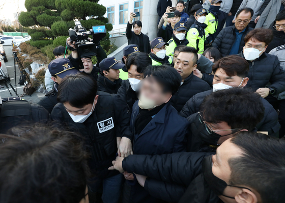 The assailant is taken to a police station in Busan on Tuesday. [NEWS1]