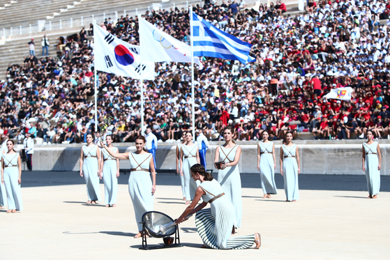 The Olympic flame is lit at the Panathenaic Stadium in Athens on Tuesday using the sun's rays and then passed to the official torch for the 2024 Gangwon Youth Olympics.  [HELLENIC OLYMPIC COMMITTEE]