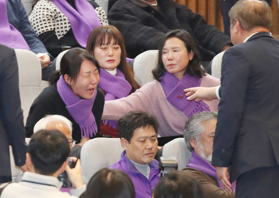 Bereaved families of the victims of the Itaewon crowd crush of Oct. 29, 2022, shed tears as a special act on investigating the tragedy passes in the National Assembly in Yeouido, western Seoul, on Tuesday. [NEWS1]