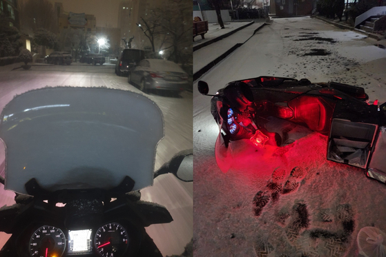 A food delivery rider and his motorcycle slipped on a snowy and slippery road on Saturday. [JOONGANG PHOTO]