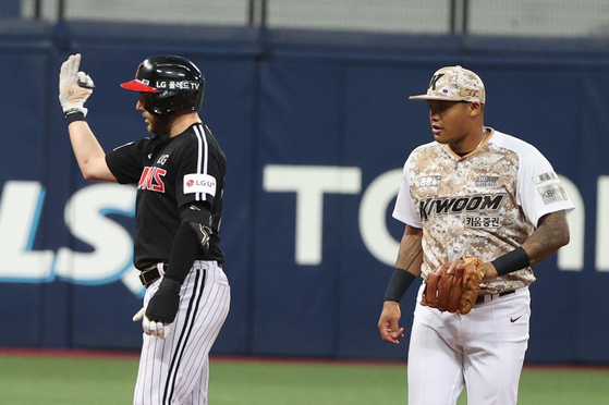 LG Twins' Austin Dean, left, celebrates after hitting a double with Kiwoom Heroes shortstop Addison Russell to his right during a game at Gocheok Sky Dome in western Seoul in July 2023. [YONHAP]