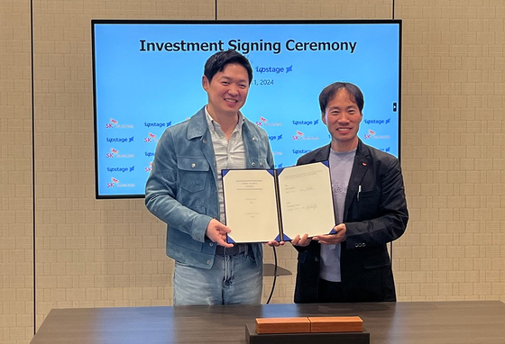 SK Networks President & COO Choi Sung-hwan, left, poses for a photo at the investment signing ceremony with Upstage CEO Kim Seong-hoon during Choi's visit to CES 2024 in Las Vegas. [SK NETWORKS]