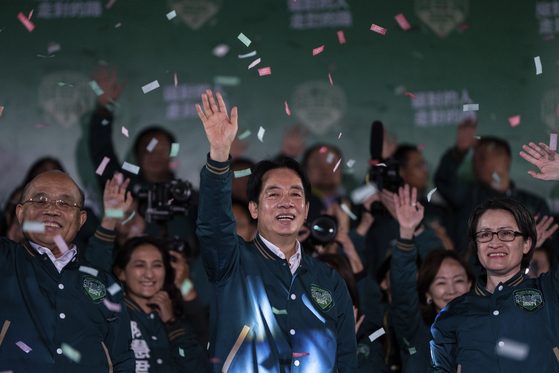 Taiwanese President-elect Lai Ching-te, also known as William Lai, left, celebrates his victory with running mate Bi-khim Hsiao in Taipei, Taiwan, Saturday. [AP/YONHAP]
