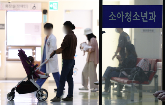 Patients and their families wait to see a pediatric doctor at Kyungpook National University Hospital in Daegu in October 2023. [YONHAP]