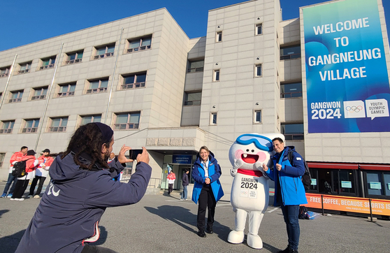 Visitors take photos with “Moongcho,” the official mascot of the Gangwon 2024 Winter Youth Olympics, on the campus of Gangneung-Wonju National University, the host of the Olympic Village, on Monday. The Winter Youth Olympics will run from Jan. 19 to Feb. 1. [YONHAP]