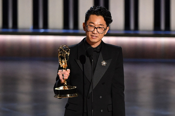 Korean American director Lee Sung-jin speaks onstage after receiving an award during the 75th Emmy Awards at the Peacock Theatre in Los Angeles. California on Tuesday. [AFP/YONHAP]