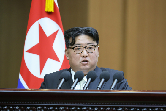 In this photo released by Pyongyang's official Rodong Sinmun on Tuesday, North Korean leader Kim Jong-un addresses the 10th session of the 14th Supreme People's Assembly in Pyongyang the previous day. [NEWS1]