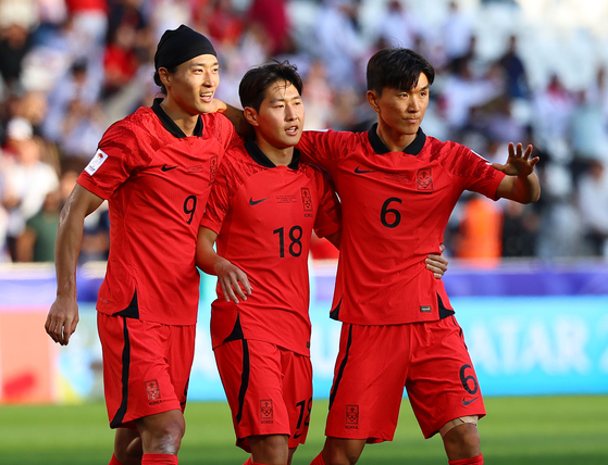 From left: Cho Gue-sung, Lee Kang-in and Hwang In-beom celebrate during an Asian Cup Group E game against Bahrain at the Jassim Bin Hamad Stadium in Qatar on Monday.  [YONHAP]