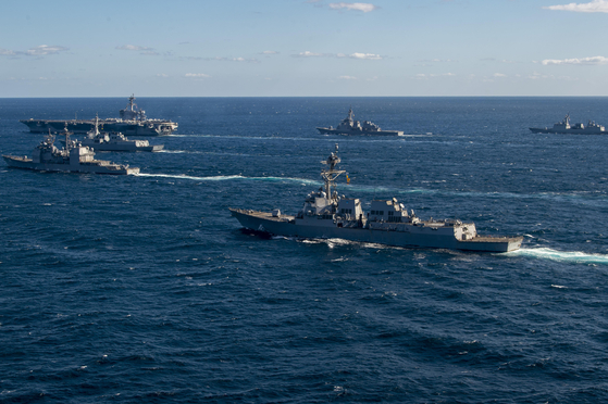 Warships from the South Korean, U.S. and Japanese navies carry out a joint exercise south of Jeju Island in this photo provided by the U.S. Navy on Wednesday. The nuclear-powered aircraft carrier USS Carl Vinson can be seen in the top left of the photo. [U.S. NAVY]