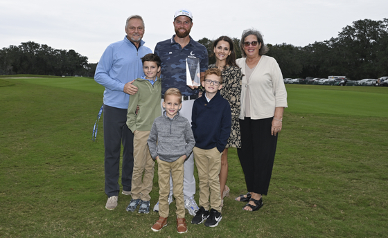 Chris Kirk poses with his family as he receives the Courage Award prior to the RSM Classic at Sea Island Golf Club in St. Simons Island, Georgia on Nov. 14, 2023.  [GETTY IMAGES]