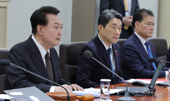 President Yoon Suk Yeol, left, speaks at a Cabinet meeting at the Yongsan presidential office in central Seoul on Tuesday. [JOINT PRESS CORPS]