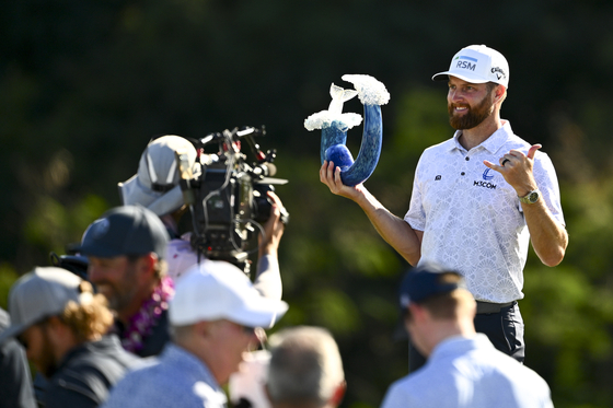 Chris Kirk poses for photos during the trophy ceremony of The Sentry at The Plantation Course at Kapalua in Hawaii on Jan. 7.  [GETTY IMAGES]