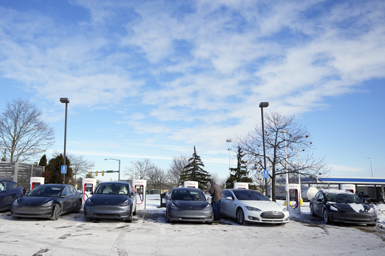 Tesla vehicles charge sit at a charging station, Wednesday, Jan. 17, 2024, in Ann Arbor, Mich. A subzero cold snap across the nation has exposed a big vulnerability for electric vehicle owners. It‘s difficult to charge the batteries in single-digit temperatures. Experts say it’s simple chemistry, that the electrons move slowly and don‘t take in or release as much energy. [AP Photo/Carlos Osorio]