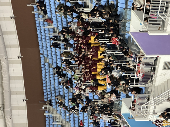 The German cheering contingent at the Gangwon 2024 Youth Olympics dances to the official ″We go high″ theme tune at the Gangneung Ice Arena in Gangneung, Gangwon on Monday.  [JIM BULLEY]